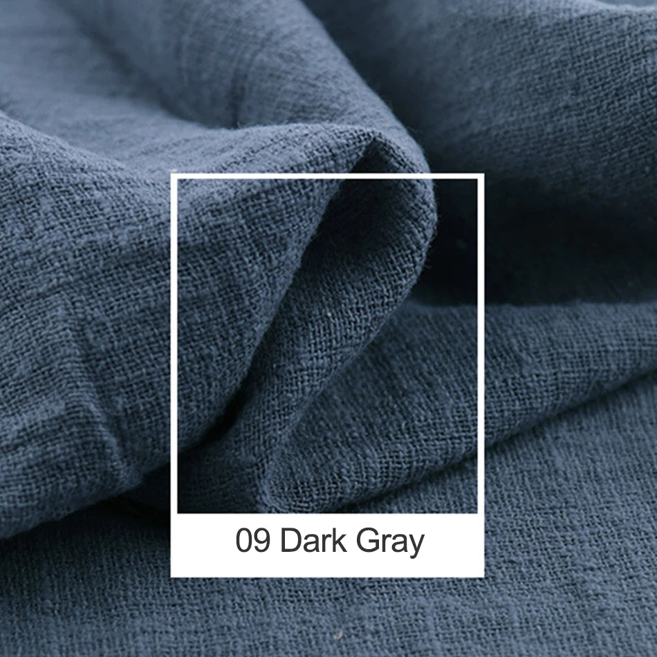 Gros plan sur un tissu gris foncé plissé et texturé, avec une étiquette blanche affichant la mention "09 Dark Gray".