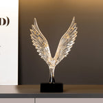 statuette animale moderne transparente dorée oiseau cerfs ailes déployées base noire