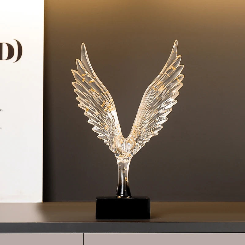 statuette animale moderne transparente dorée oiseau cerfs ailes déployées base noire
