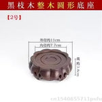 support décoration bois marron foncé texture naturelle gravure circulaire classique artisanal théière vase boule