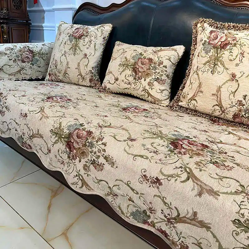 Élégant canapé tapissé de motifs floraux et de rinceaux vintage, avec des coussins assortis, créant une ambiance chaleureuse et sophistiquée dans un intérieur.