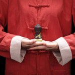 statuette bouddha artisanale couleur noir orange jaune bleu texture granulée méditatif argile violette