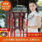 lanterne traditionnelle chinoise bois sculpté rouge décorative pompon fête mariage jardin