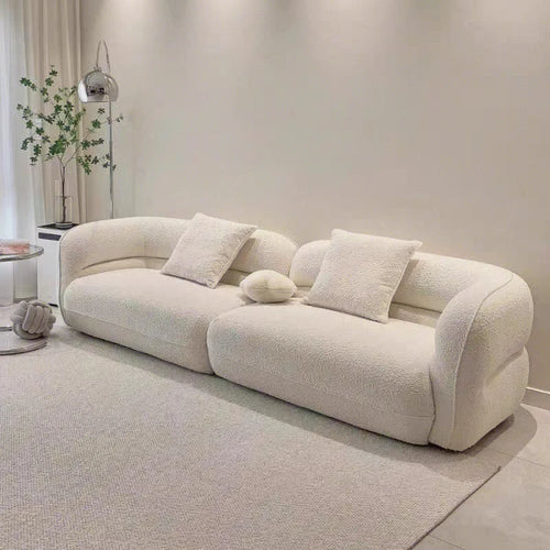 canapé moderne vert olive beige clair tissu bouclé confortable pieds ronds coussins décoratifs forme