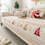 Canapé élégant et confortable décoré de motifs festifs en rouge, jaune et blanc, donnant une ambiance chaleureuse et invitante pour la période des fêtes.