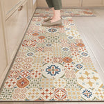 Le sol de la cuisine est recouvert d'un joli tapis de carreaux de style vintage, aux motifs colorés et géométriques, créant une ambiance chaleureuse et accueillante.