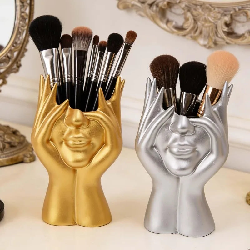 support pinceaux maquillage or argent noir visage stylisé moderne sculpturaliaux pinceaux