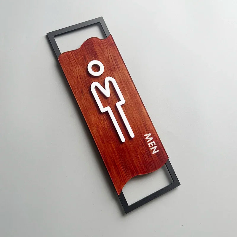 signalisation toilettes moderne symboles homme femme texte TOILET bois brun clair blanc tringle noire