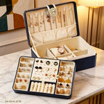 boîtes bijoux simili cuir bleu marine blanc rose pâle compartiments montres boucles doreilles modernes