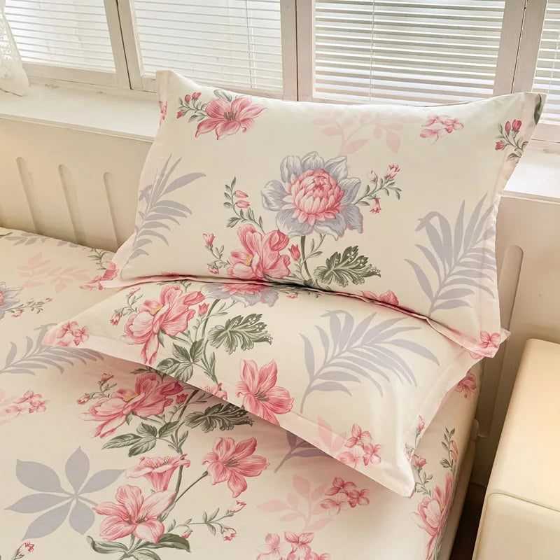 Magnifique parure de lit avec un motif floral aux nuances de rose, gris et blanc, créant une atmosphère délicate et apaisante dans la chambre.
