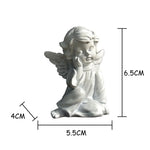 statue ange enfant triste sculpture résine détaillée plumes livres dorés fleurs bleues vintage