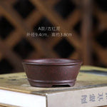 cache pot céramique noir classique motif lignes verticales finition glacé plante verte table decoration