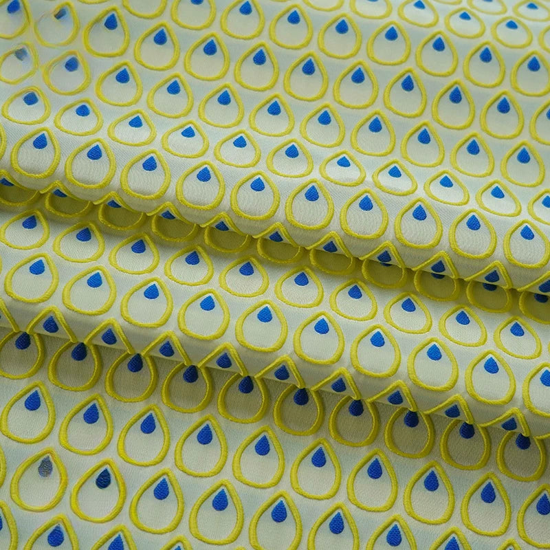 tissu polyester jaune bleu motif gouttes plumes decoratif moderne largeur 150cm graphique Jacquard