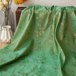 tissu polyester floral semi transparent vert rose motifs dorés traditionnel élégant texturé 145cm