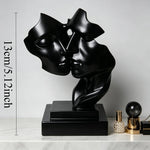 sculpture moderne deux visages enlacés blanc noir doré argenté minimaliste surface lisse socle