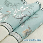 Tissu jacquard ornementé de motifs floraux et animaux aquatiques sur un fond vert clair.