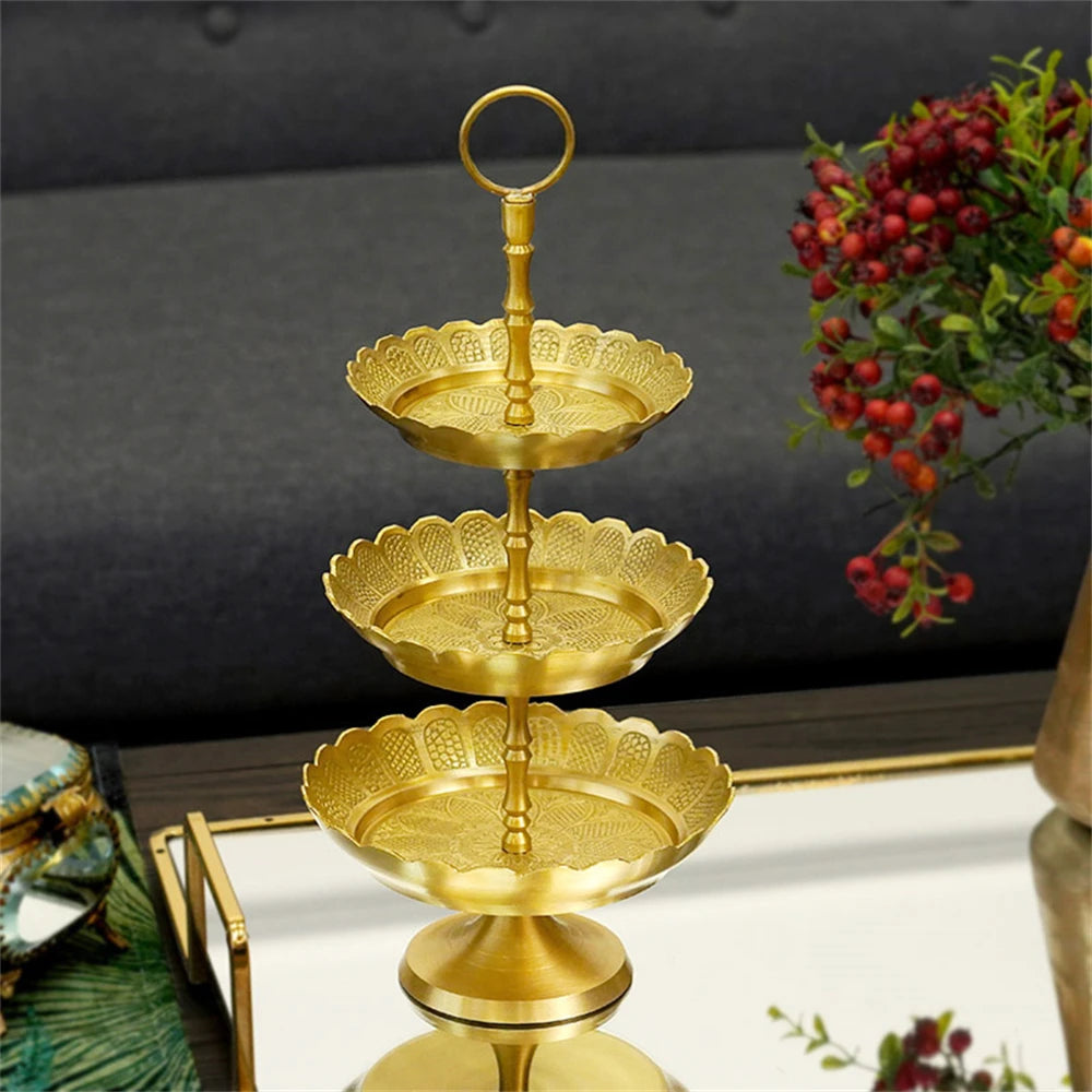 Une élégante tour dorée composée de plateaux ornés, offrant un magnifique présentoir pour des plats de fête ou des desserts.