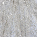 tissu dentelle feuilles brodé élégant polyester translucide blanc argent materiaux couture robes mariage