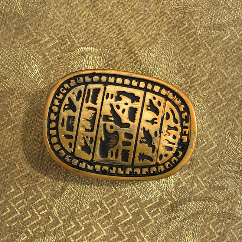 ornement égyptien ancien statuette scarabées or noirs motifs hiéroglyphiques texturés artisanal