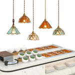suspension lumineuse verre teinté art deco or marron bleu clair motifs géométriques opacité chaînes