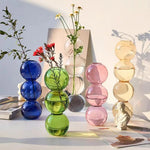 vase moderne transparent sphères empilées jaune clair rose bleu vert brun