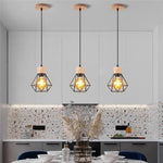 suspension lumineuse industrielle cage métal finition bois naturel ampoule filament noir moderne