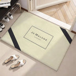 tapis moderne logo jo malone londres beige clair noir bordure diagonale résistant décoloration polyester