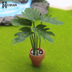 décoration intérieure plante artificielle fleurs feuilles pot terre cuite galets blancs moderne minimaliste