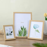 cadres photo bois clair marron blanc minimaliste motifs floraux supports mural poser triangles