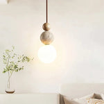 lampe suspendue pierre moderne ampoule g9 blanc beige marron foncé texture granulée lumière opaques
