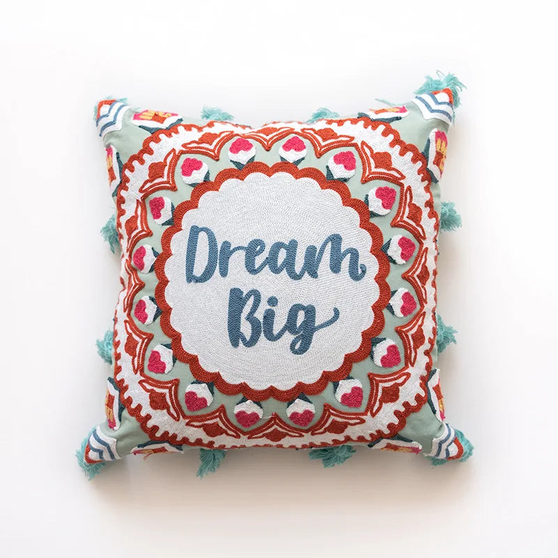 Coussin décoratif avec motif floral coloré et inscription "Dream big".