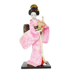 poupée japonaise geisha argile broderie florale motifs géométriques accessoires traditionnels blanc rouge vert bleu