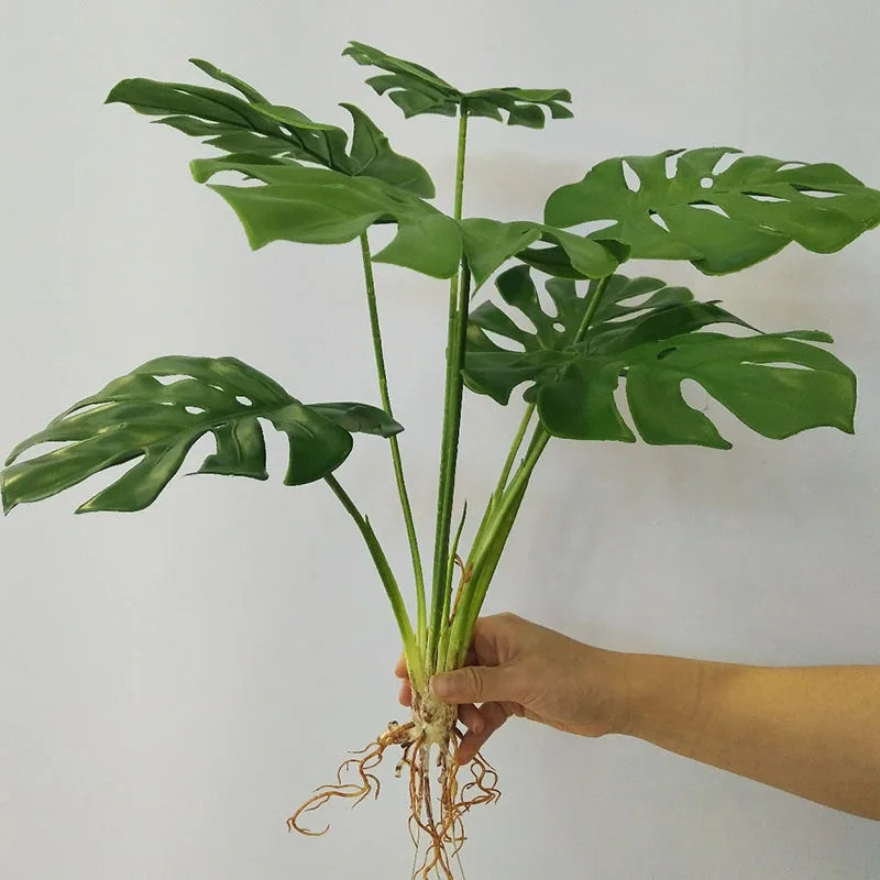 plantes artificielles vertes feuilles larges moderne decoration intérieure feuilles nervures perforations racines apparentes minimaliste