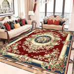 Luxueuse salle de séjour meublée avec un canapé et des fauteuils ornés de riches motifs floraux sur un tapis rouge de style oriental.