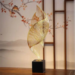 sculpture décorative feuille stylisée or noir moderne minimaliste ajourée asiatique fixée socle bois