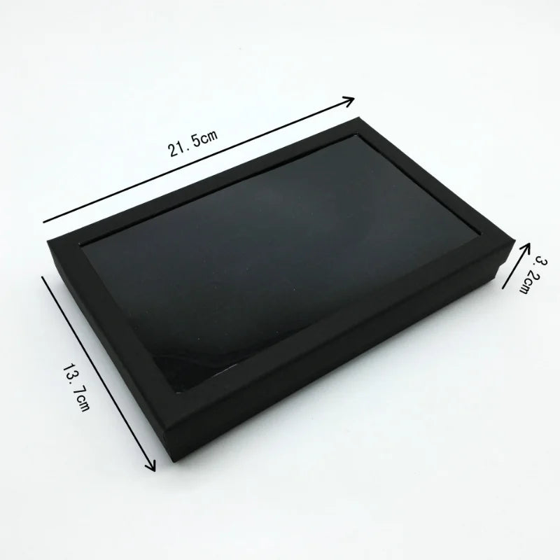 présentoir bijoux moderne boîte transparente 21.5cm 13.7cm 3.2cm alvéoles rectangulaires plusieurs bagues noires argentées