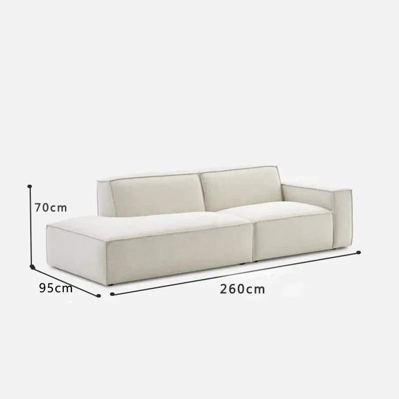 canapé d'angle moderne beige clair uni confortable salon minimaliste inclusion coussins tapis