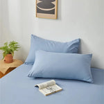taies d'oreiller lisses polyester coton gris bleu rose blanc modernes literie décoration chambre voyage