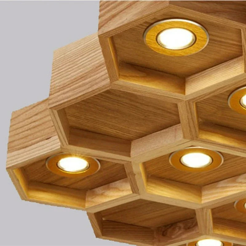 lumière suspendue bois clair nid d'abeille hexagonal modernes led câbles argentés structure géométrique