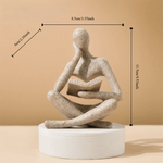 figurine deco moderne or noir blanc personne assise livre socle chambre abstraction minimalisme