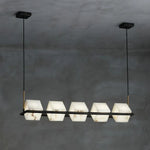 suspension lumineuse moderne marbre noir blanc or rose fixée câbles chambre salon