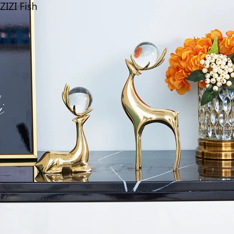 statues cerfs dorées boule cristal moderne décoration vase fleurs artificielles tableau noir