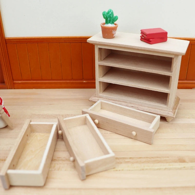 meuble miniature commode trois tiroirs bois naturel tableau nuit étoilée livres cactus figurine noël