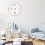 horloge murale moderne chiffres relief aiguilles fines blanc rose doré noir minimaliste