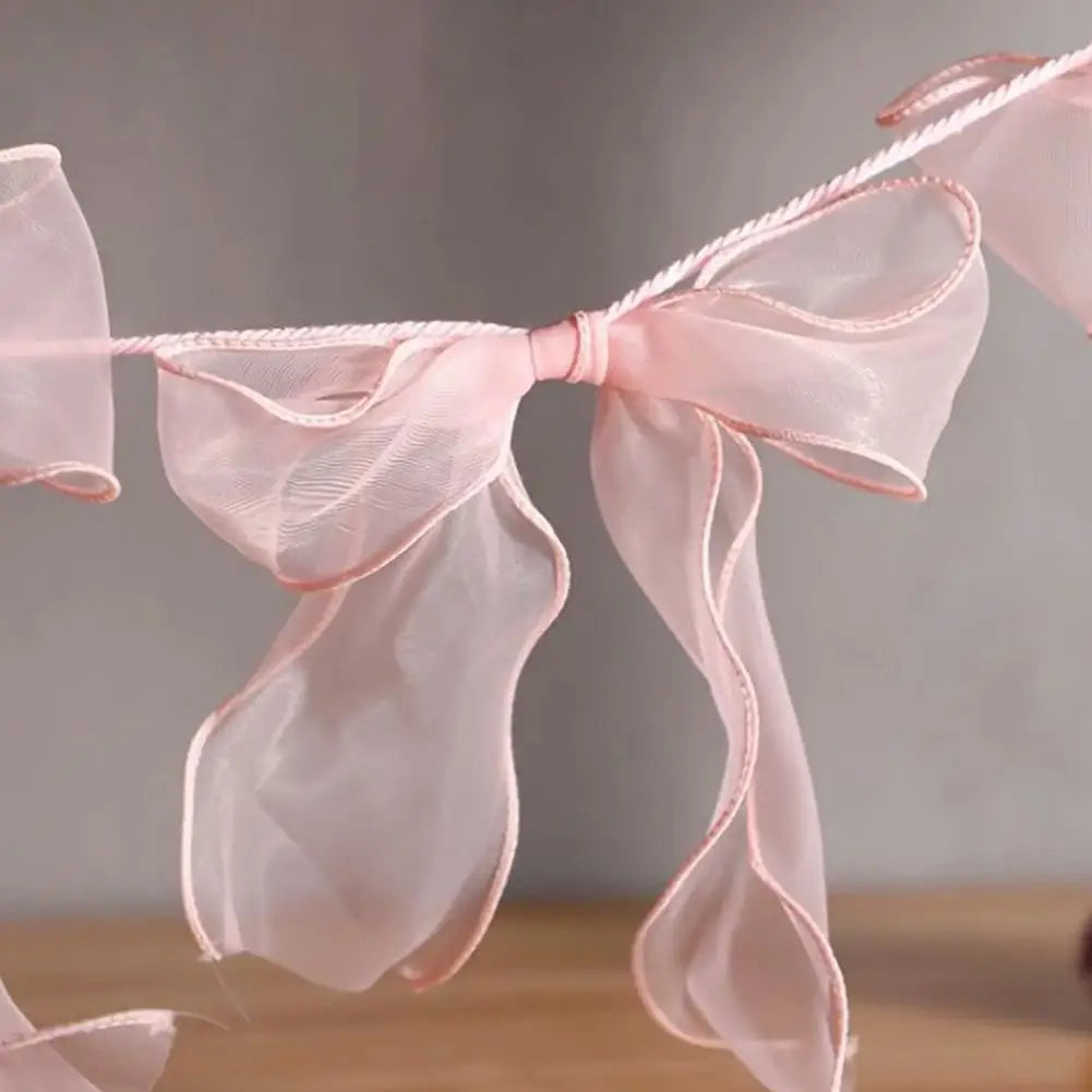 décoration festive guirlande nœuds rose tissu texturé semi transparent mariage anniversaire enfant baby shower