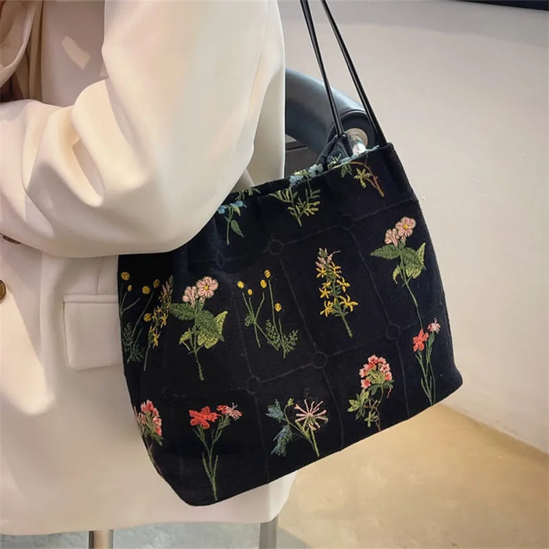 sac main noir broderie fleurs moderne poignées détachables papier stylo bouteille lotion