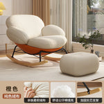 fauteuil bascule moderne beige noir orange roulettes coussin repos minimaliste salon
