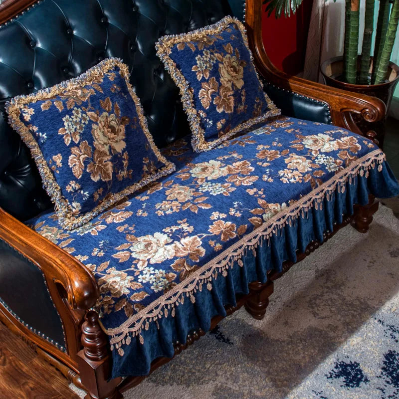 Ce canapé à trois places orné d'un motif floral bleu et doré avec franges est un élément d'ameublement élégant et décoratif.