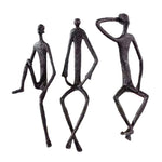 statues modernes minimalistes figures humaines assises noir texture brut forge lunettes livresintérieur