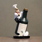 statue cuisinier cartoon uniforme blanc tablier noir chapeau cuillère dorée bouteille pot pomme terre